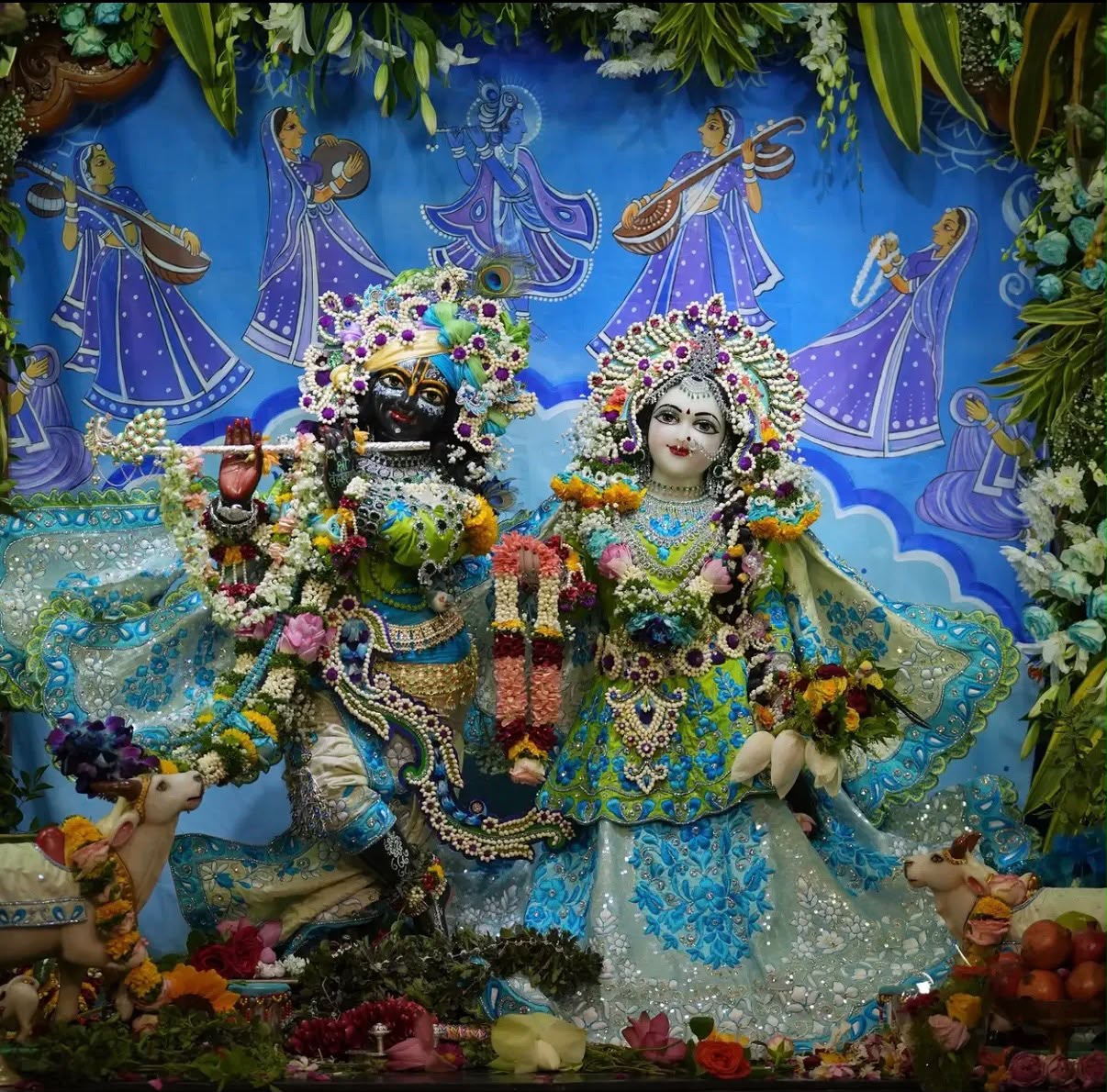 Radha and Krishna deities in blue and green attire, shown as collection inspiration