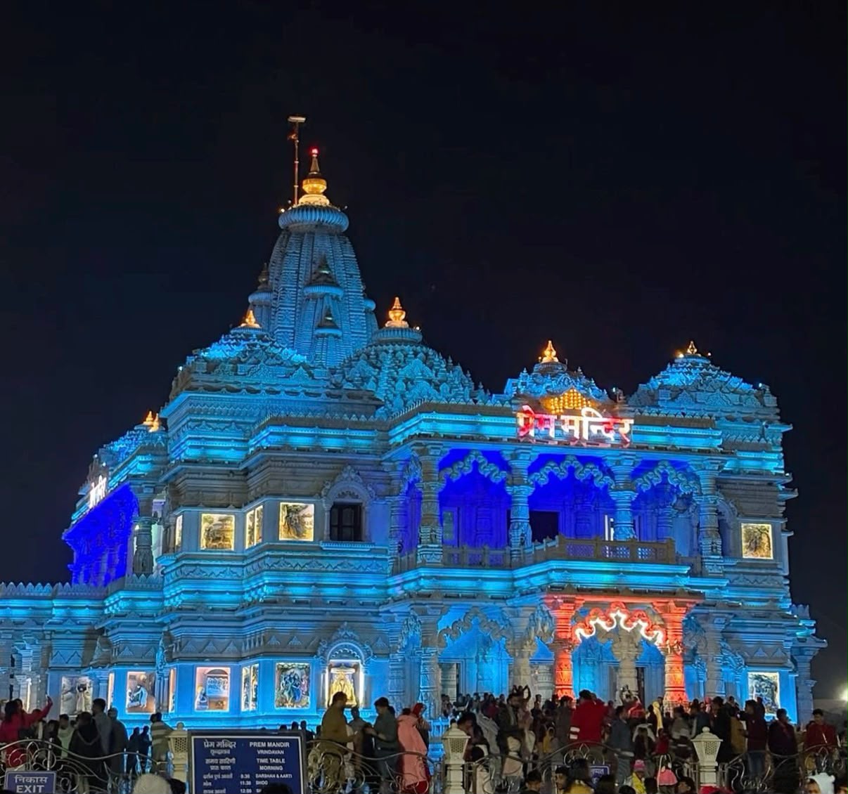 Prem Mandir illuminated in blue against the night sky